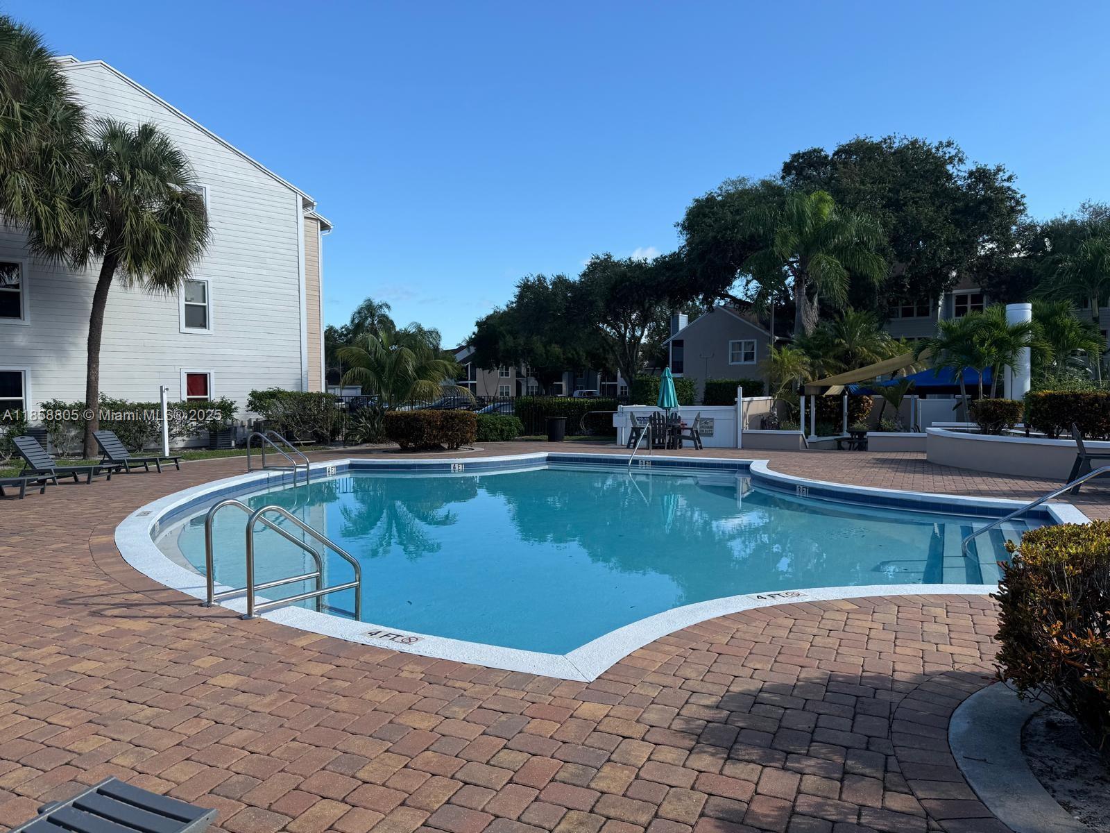 2319 North Congress Avenue, Unit 15 Boynton Beach, FL 33426 - Photo 2 of 20 a view of a swimming pool with a patio