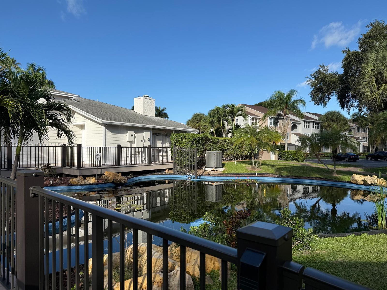 2319 North Congress Avenue, Unit 15 Boynton Beach, FL 33426 - Photo 4 of 20 a view of a lake with a garden and outdoor seating