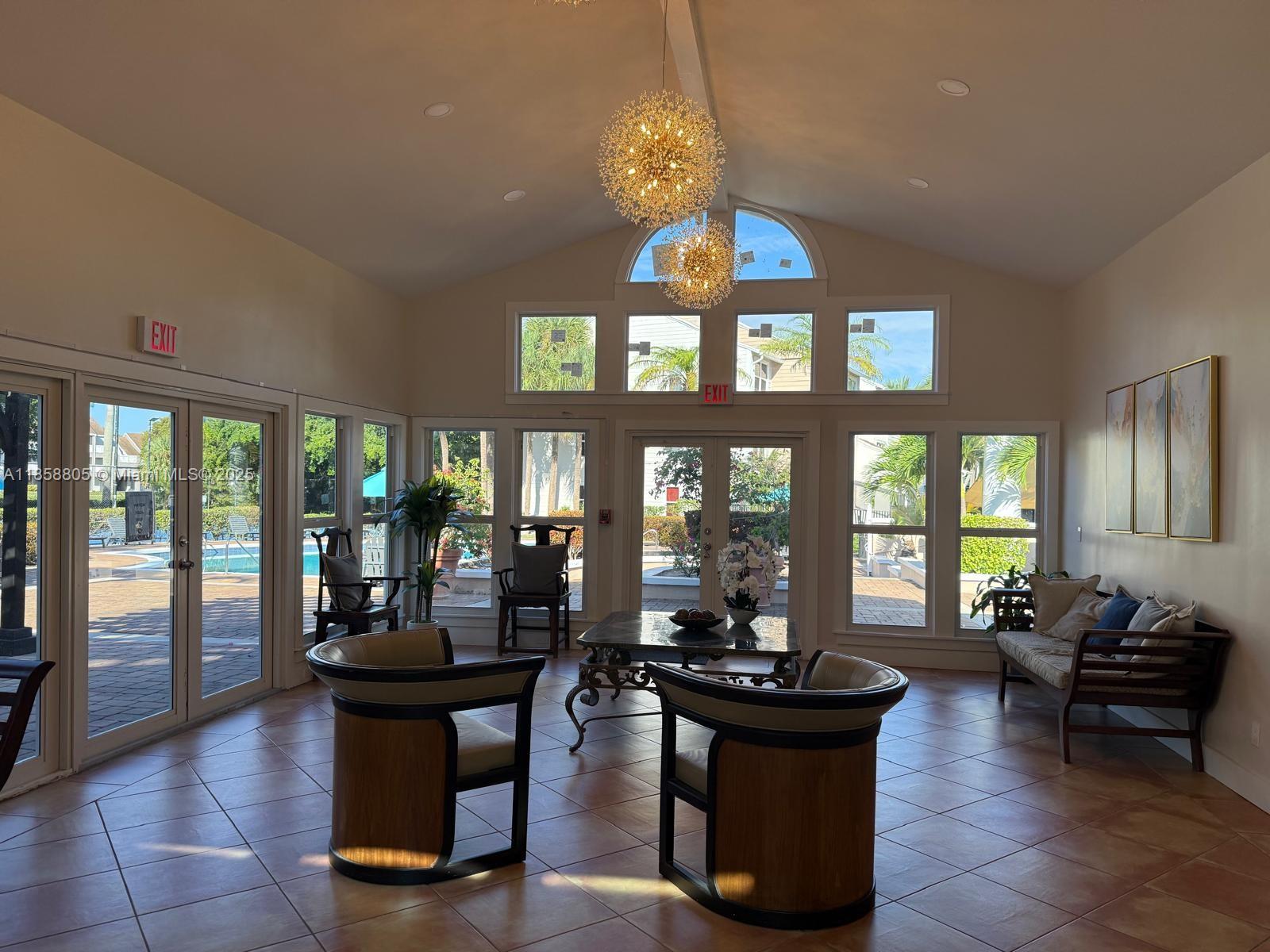 2319 North Congress Avenue, Unit 15 Boynton Beach, FL 33426 - Photo 5 of 20 a view of a dining room with furniture a chandelier and large windows