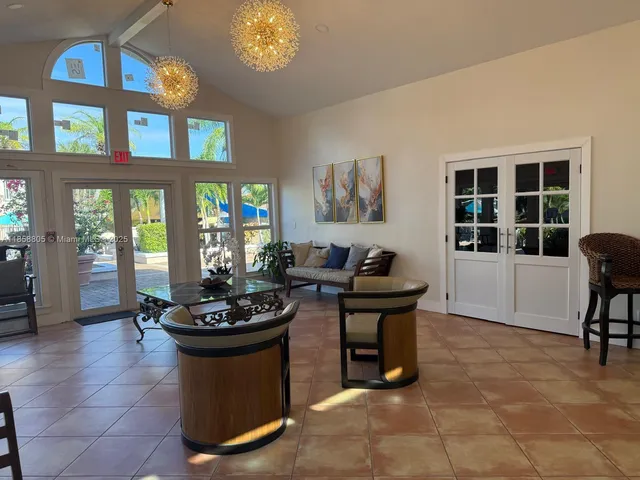 a living room with furniture a window and a chandelier