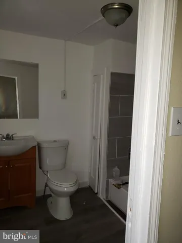 a white toilet sitting next to a bathroom sink