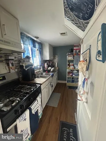 a kitchen with a stove and a refrigerator