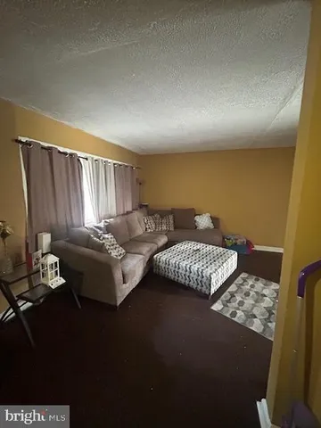 a living room with a couch and a window