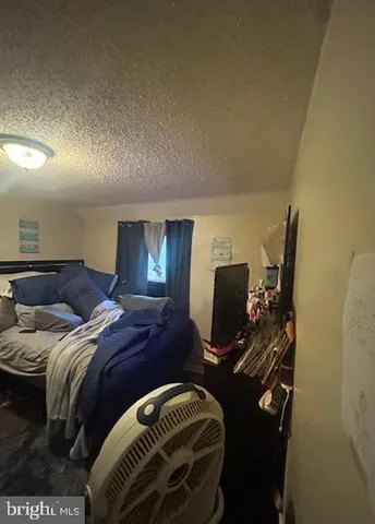 a bedroom with bed and a mirror