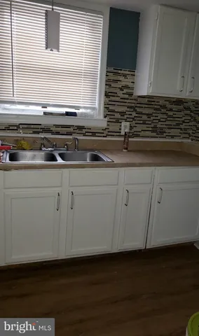 a kitchen with stainless steel appliances granite countertop a sink a stove and a microwave