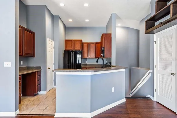 a kitchen with stainless steel appliances granite countertop a refrigerator and a sink
