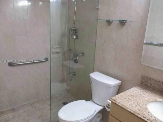 a kitchen with stainless steel appliances granite countertop a refrigerator and a stove