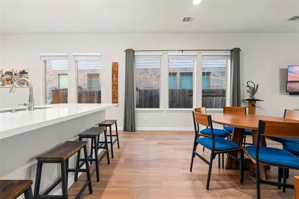 a view of a dining room with furniture and wooden floor