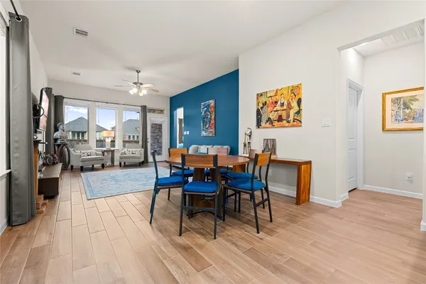 a view of a dining room with furniture and wooden floor