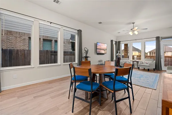 a view of a dining room with furniture window and wooden floor