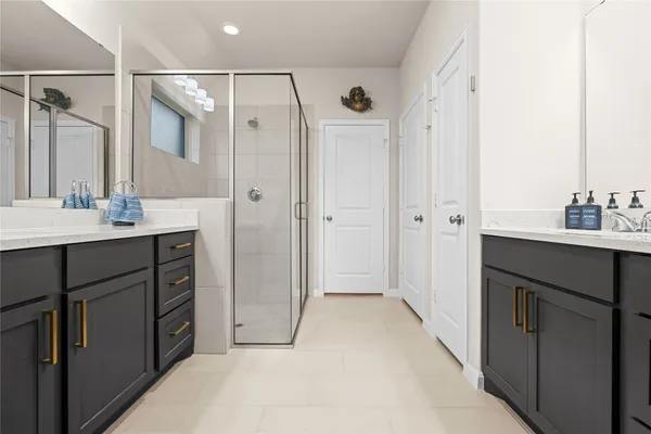 a bathroom with a shower sink vanity and mirror