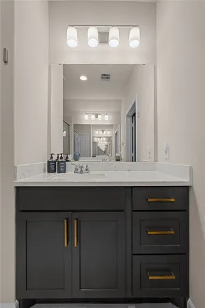 a bathroom with a sink vanity and a mirror