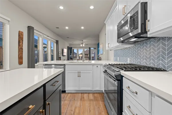 a kitchen with a sink stove and cabinets