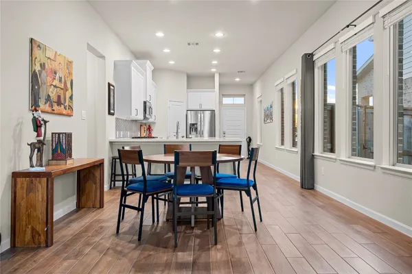 a view of a dining room with furniture kitchen and wooden floor