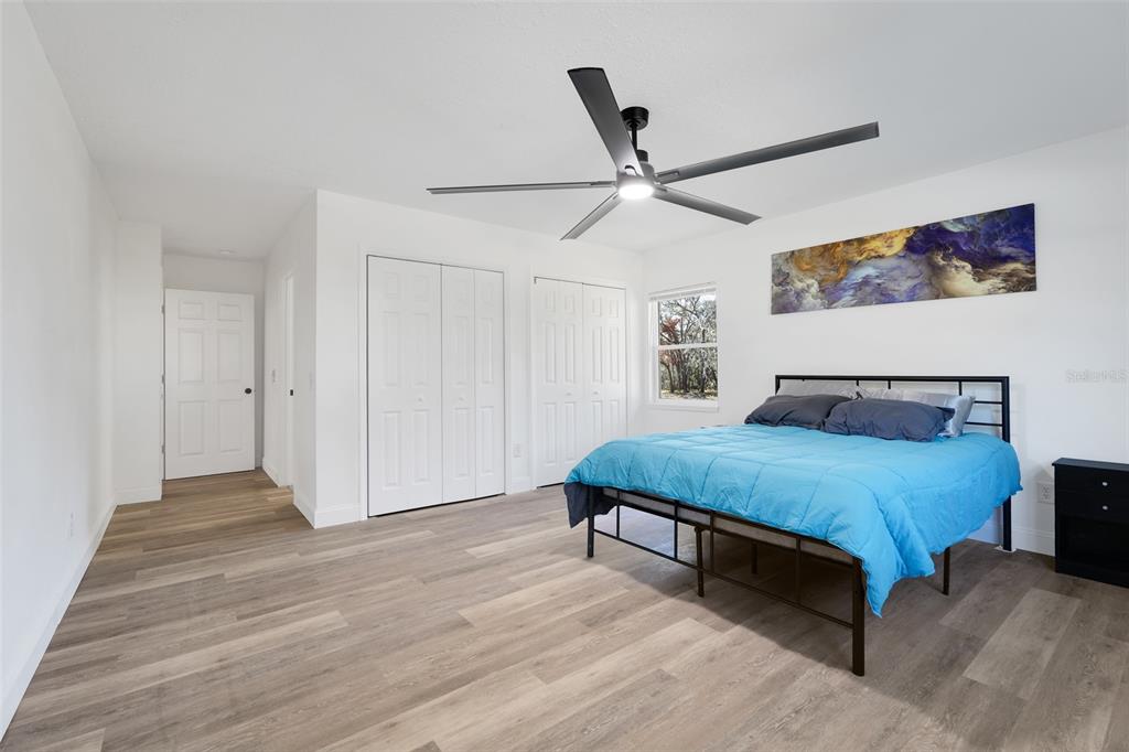 828 St Anne Shrine Road Lake Wales, FL 33898 - Photo 14 of 39 a spacious bedroom with a bed and a chandelier