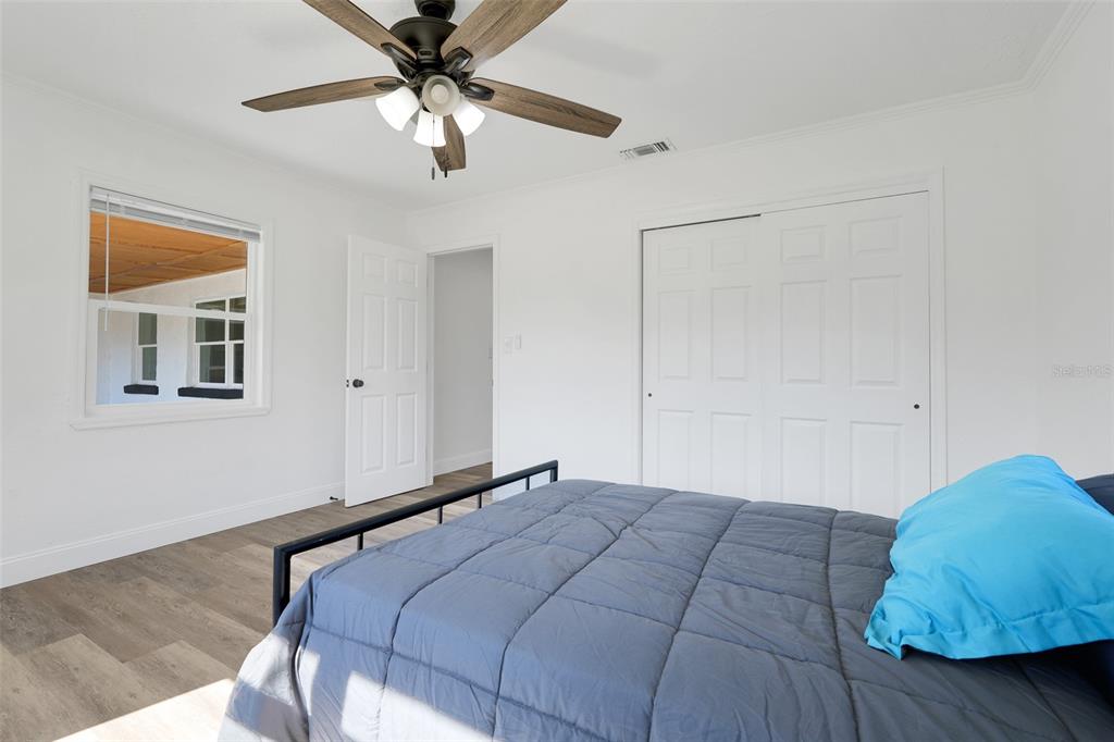 828 St Anne Shrine Road Lake Wales, FL 33898 - Photo 19 of 39 a bedroom with a large bed and a ceiling fan