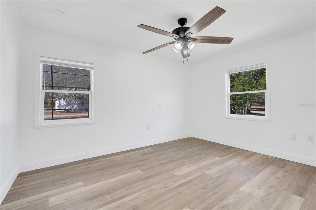 828 St Anne Shrine Road Lake Wales, FL 33898 - Photo 19 of 39 a view of a big room with wooden floor ceiling fan and windows