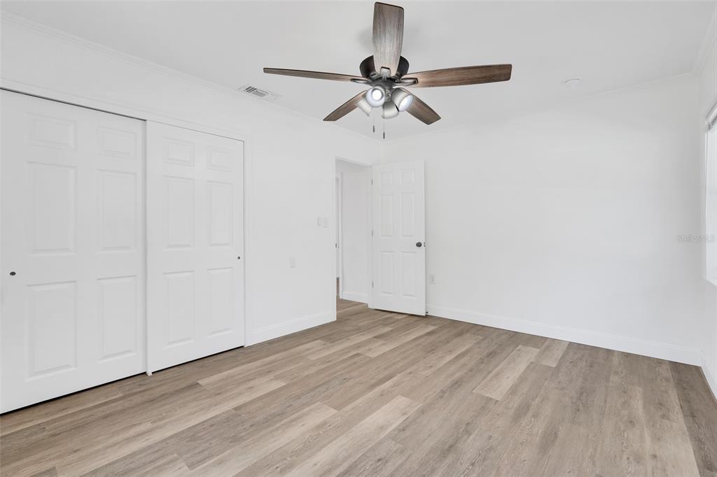 828 St Anne Shrine Road Lake Wales, FL 33898 - Photo 20 of 39 a view of a room with wooden floor closet and ceiling fan