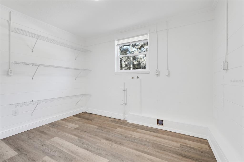 828 St Anne Shrine Road Lake Wales, FL 33898 - Photo 22 of 39 an empty room with wooden floor and windows