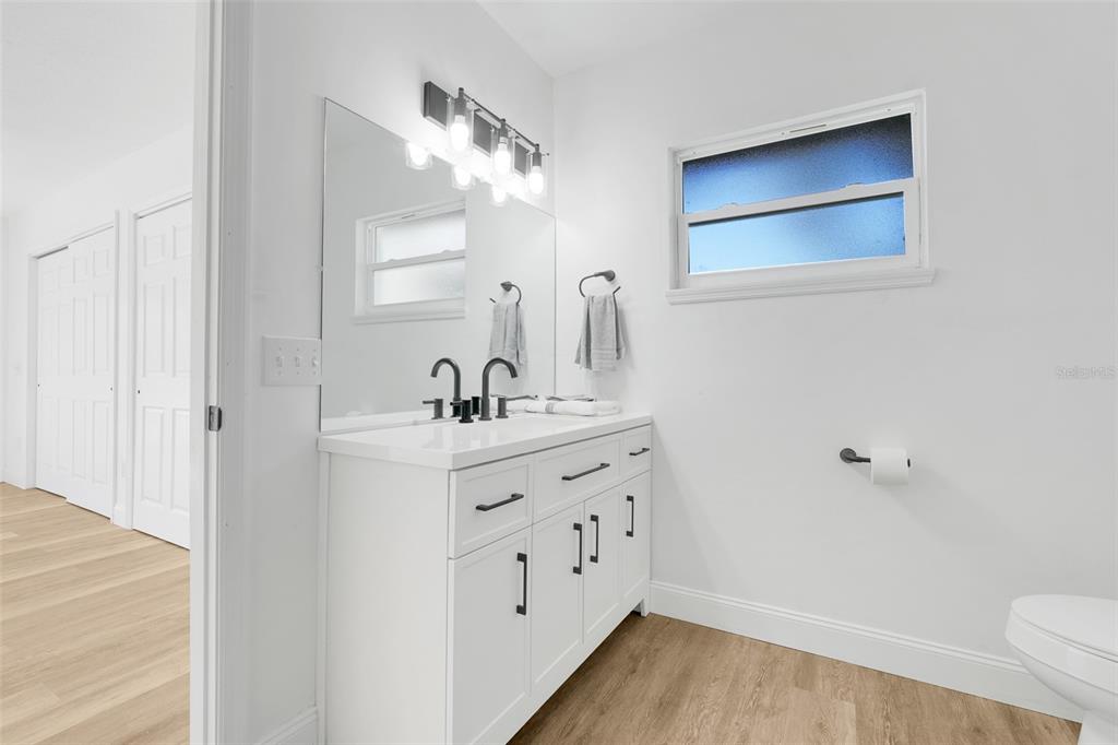 828 St Anne Shrine Road Lake Wales, FL 33898 - Photo 27 of 39 a bathroom with a double vanity sink a toilet and a mirror