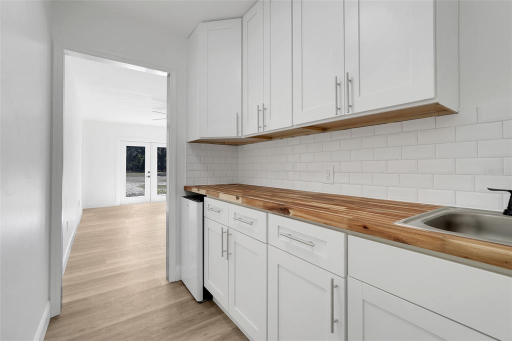 828 St Anne Shrine Road Lake Wales, FL 33898 - Photo 30 of 39 a kitchen with granite countertop white cabinets and sink