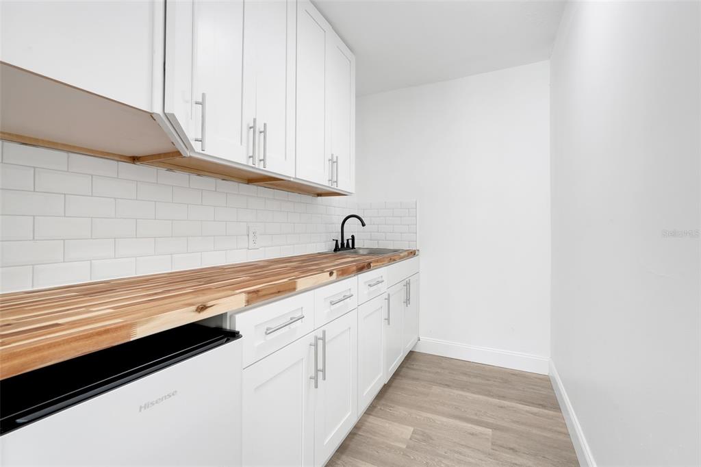 828 St Anne Shrine Road Lake Wales, FL 33898 - Photo 30 of 39 a kitchen with granite countertop white cabinets and a sink
