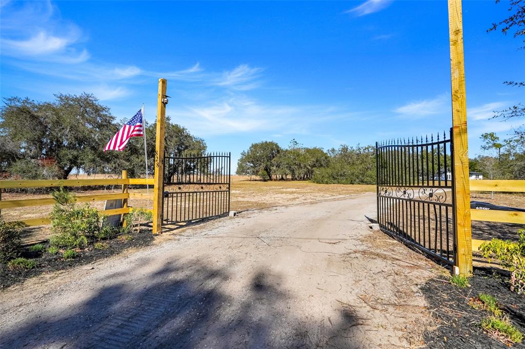 828 St Anne Shrine Road Lake Wales, FL 33898 - Photo 34 of 39 a view of a pathway with a wrought fence