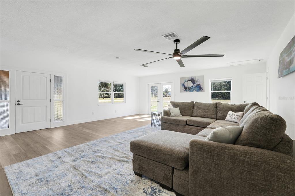 828 St Anne Shrine Road Lake Wales, FL 33898 - Photo 4 of 39 a living room with furniture a window and a ceiling fan