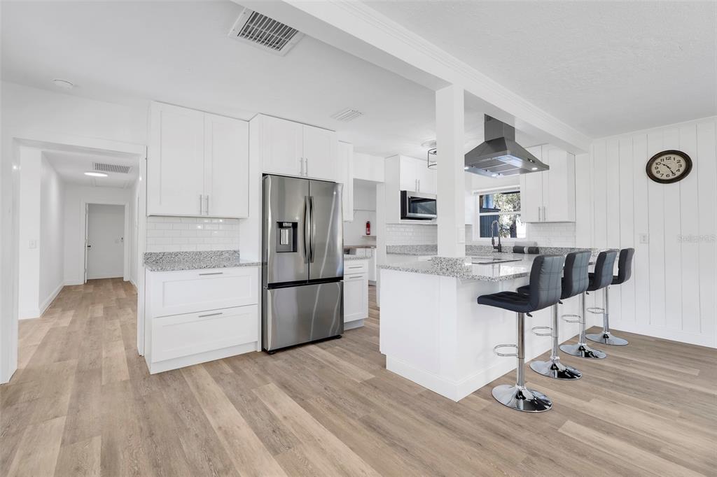 828 St Anne Shrine Road Lake Wales, FL 33898 - Photo 6 of 39 a kitchen with a refrigerator and a stove top oven