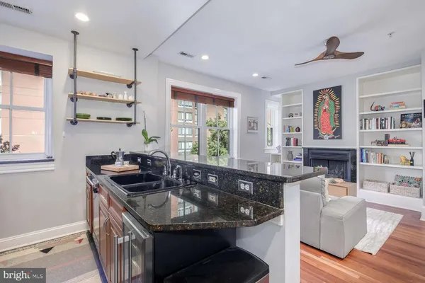 a kitchen with stainless steel appliances granite countertop a sink stove and cabinets