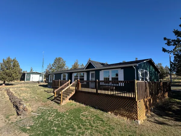 a view of a house with a wooden deck