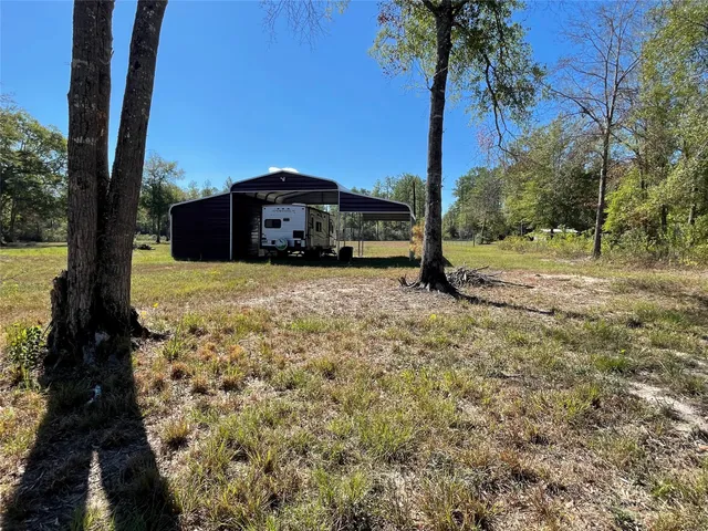 a yellow house with trees in front of it