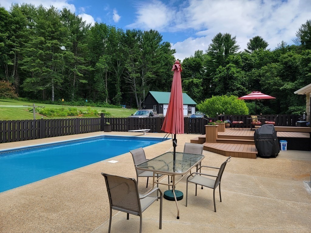 282 Old Gilbertville Road Ware, MA 01082 - Photo 1 of 31 a view of a patio with a table chairs and a swimming pool