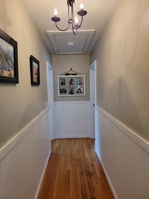 282 Old Gilbertville Road Ware, MA 01082 - Photo 14 of 31 a view of a hallway with wooden floor and chandelier