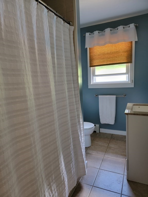 282 Old Gilbertville Road Ware, MA 01082 - Photo 17 of 31 a bathroom with a toilet and a shower curtain