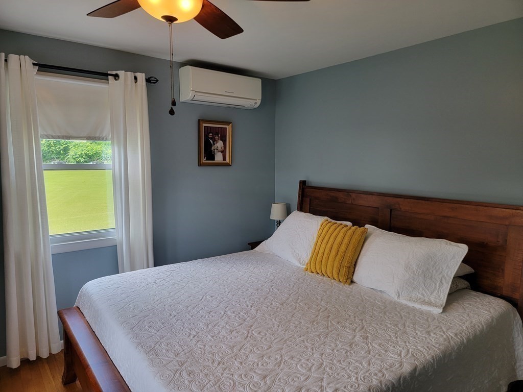 282 Old Gilbertville Road Ware, MA 01082 - Photo 20 of 31 a bedroom with a bed and a chandelier