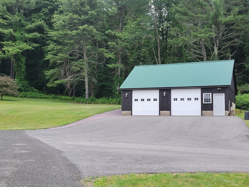 282 Old Gilbertville Road Ware, MA 01082 - Photo 4 of 31 a front view of a house with a yard and garage