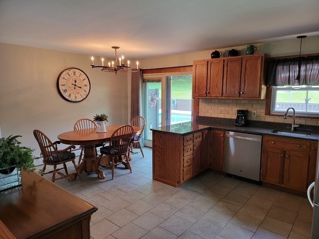 282 Old Gilbertville Road Ware, MA 01082 - Photo 10 of 31 a kitchen with granite countertop a table chairs and a sink