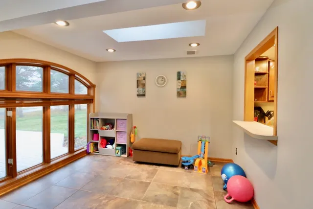 a bedroom with furniture and a large window