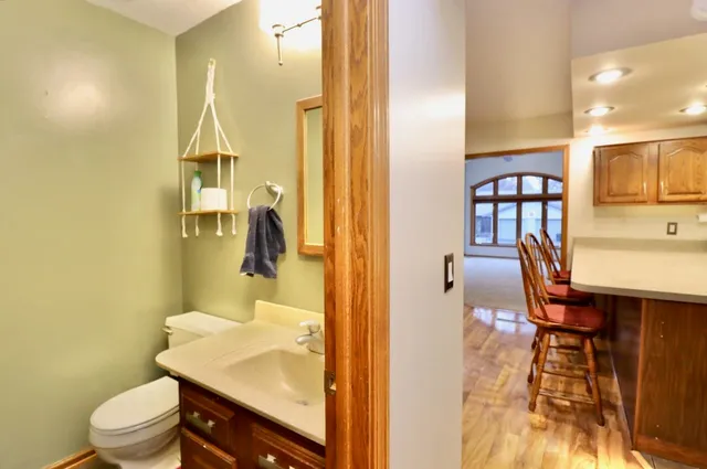 a bathroom with a sink a toilet and a mirror