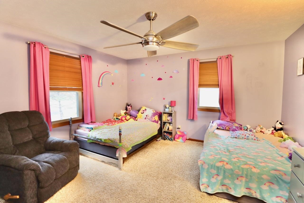 543 Fieldcrest Road Belvidere, IL 61008 - Photo 19 of 24 a bedroom with a bed couch and window