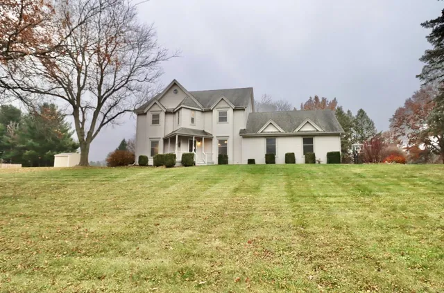 a front view of house with yard and green space