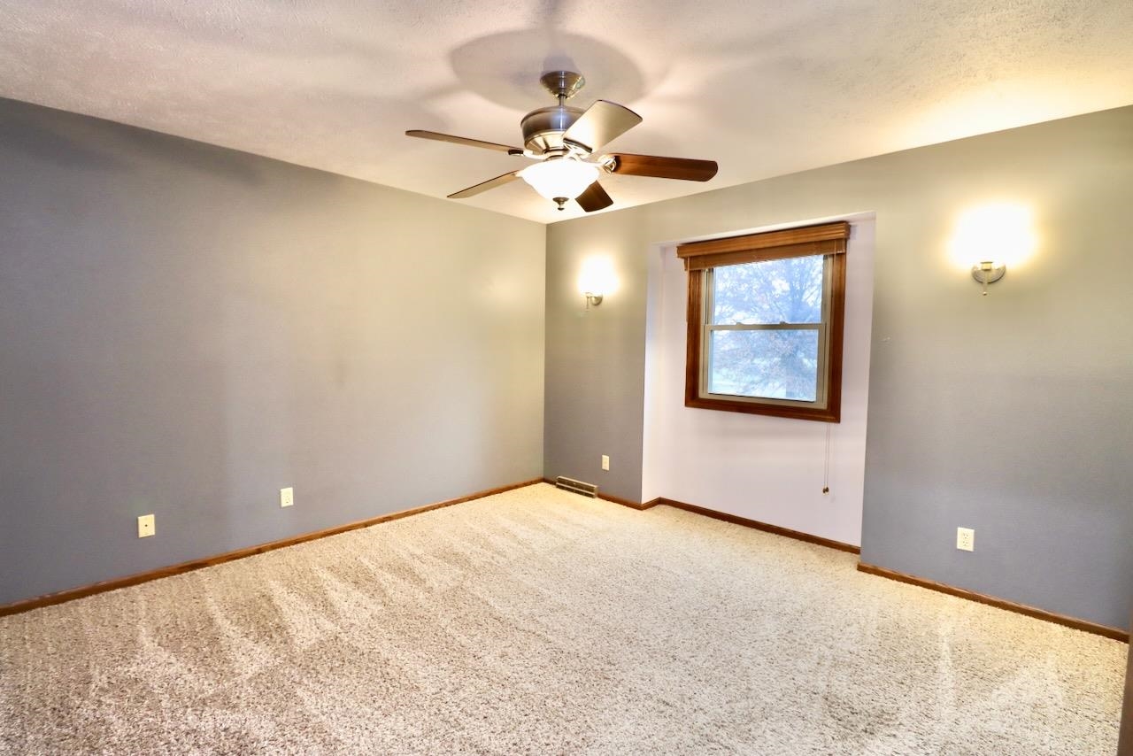 543 Fieldcrest Road Belvidere, IL 61008 - Photo 21 of 24 a view of a room with a ceiling fan and a window