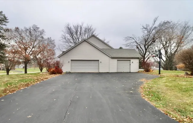 a view of a house with a yard and garage