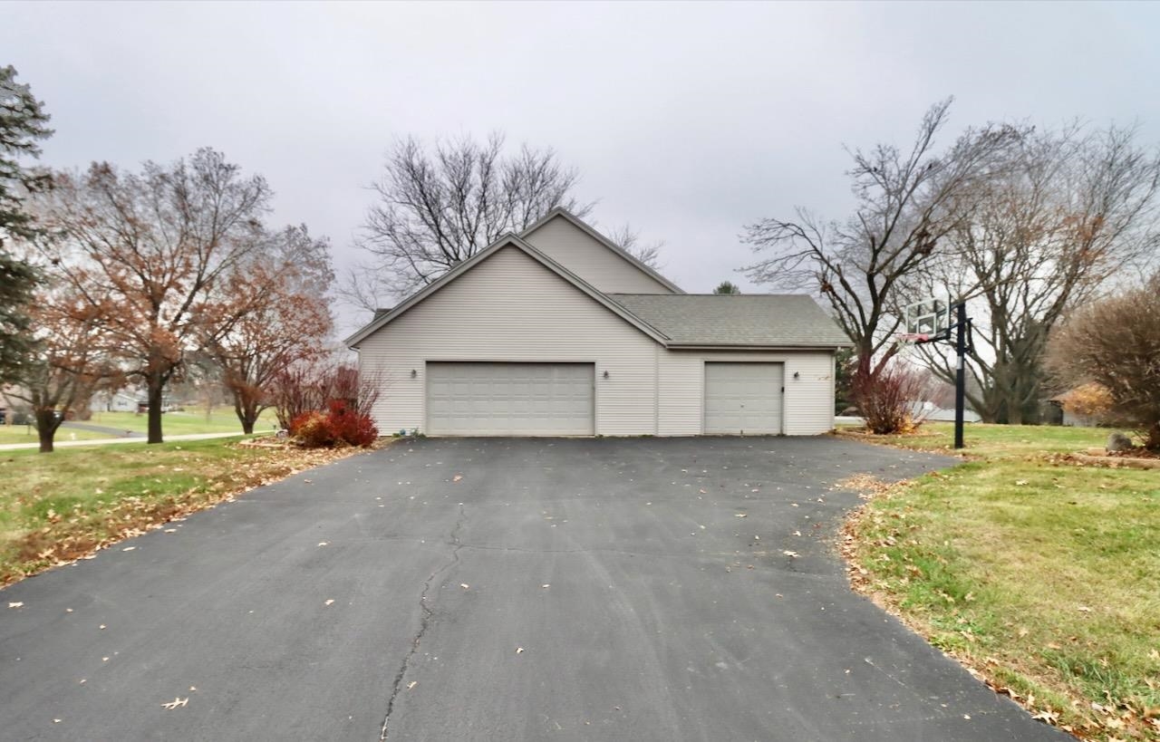 543 Fieldcrest Road Belvidere, IL 61008 - Photo 23 of 24 a view of a house with a yard and garage
