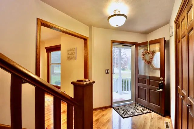 a view of a entryway door with wooden floor