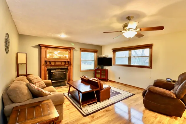 a living room with furniture ceiling fan and a flat screen tv