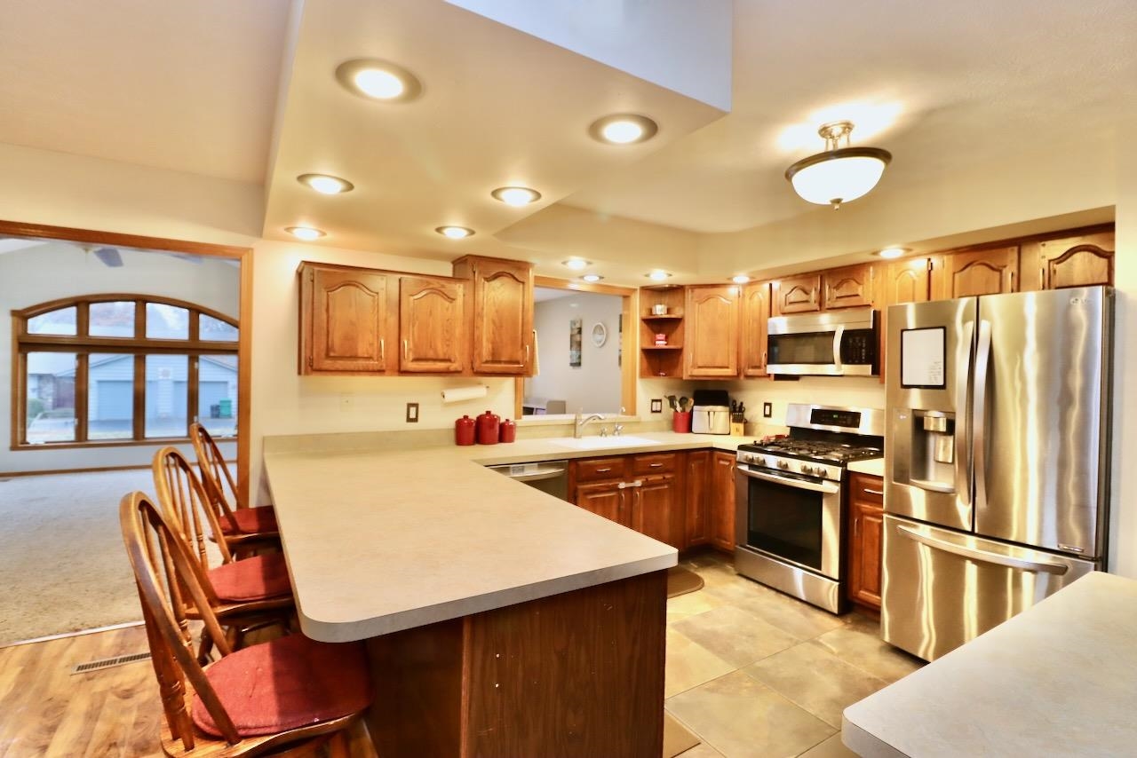 543 Fieldcrest Road Belvidere, IL 61008 - Photo 8 of 24 a kitchen with stainless steel appliances granite countertop a stove refrigerator sink and cabinets