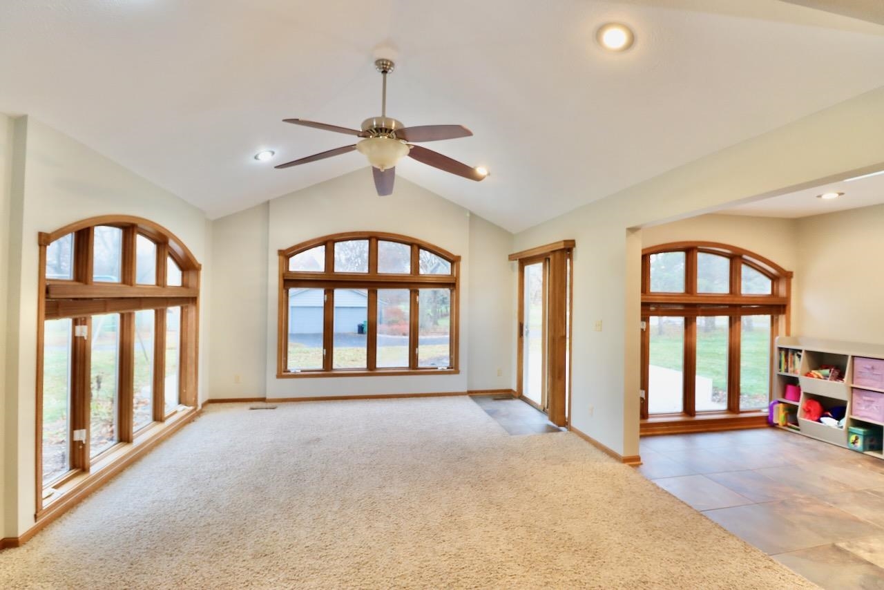 543 Fieldcrest Road Belvidere, IL 61008 - Photo 10 of 24 a view of an empty room with a window and a kitchen