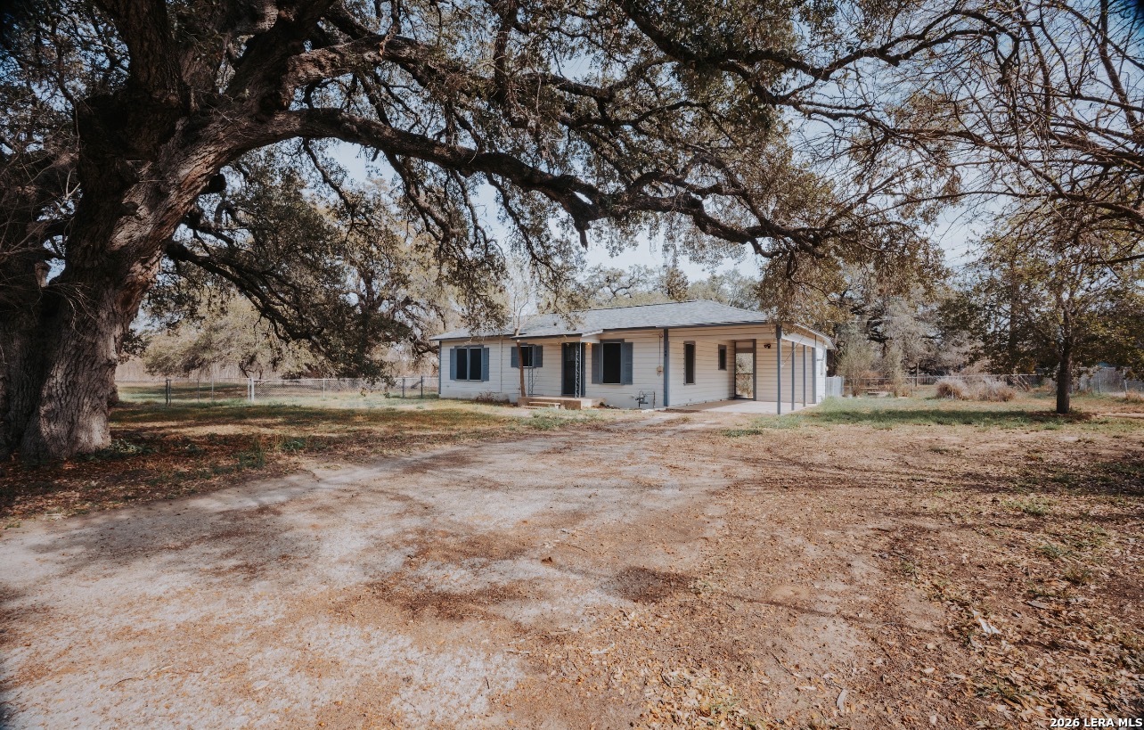 149 South Carroll Street Poth, TX 78147 - Photo 24 of 28 a front view of house with yard and trees around